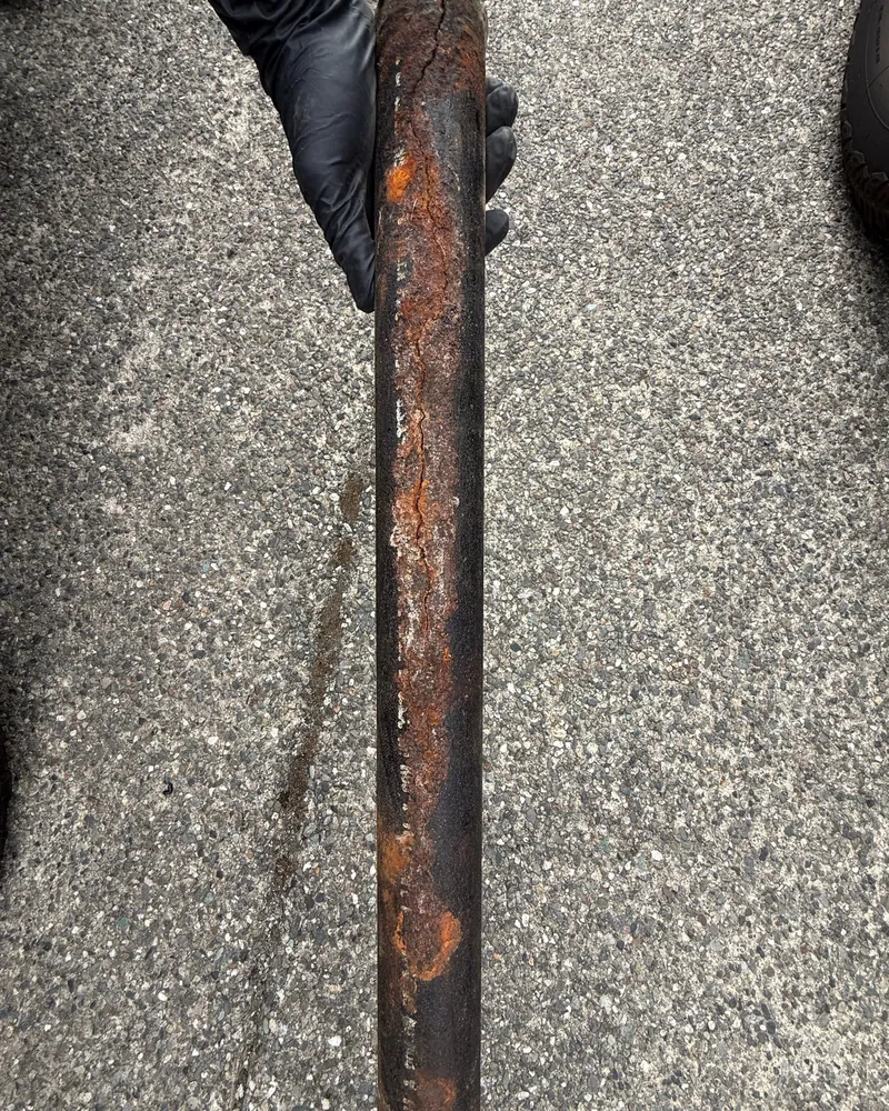 Cracked, corroded cast iron drain pipe we cut out