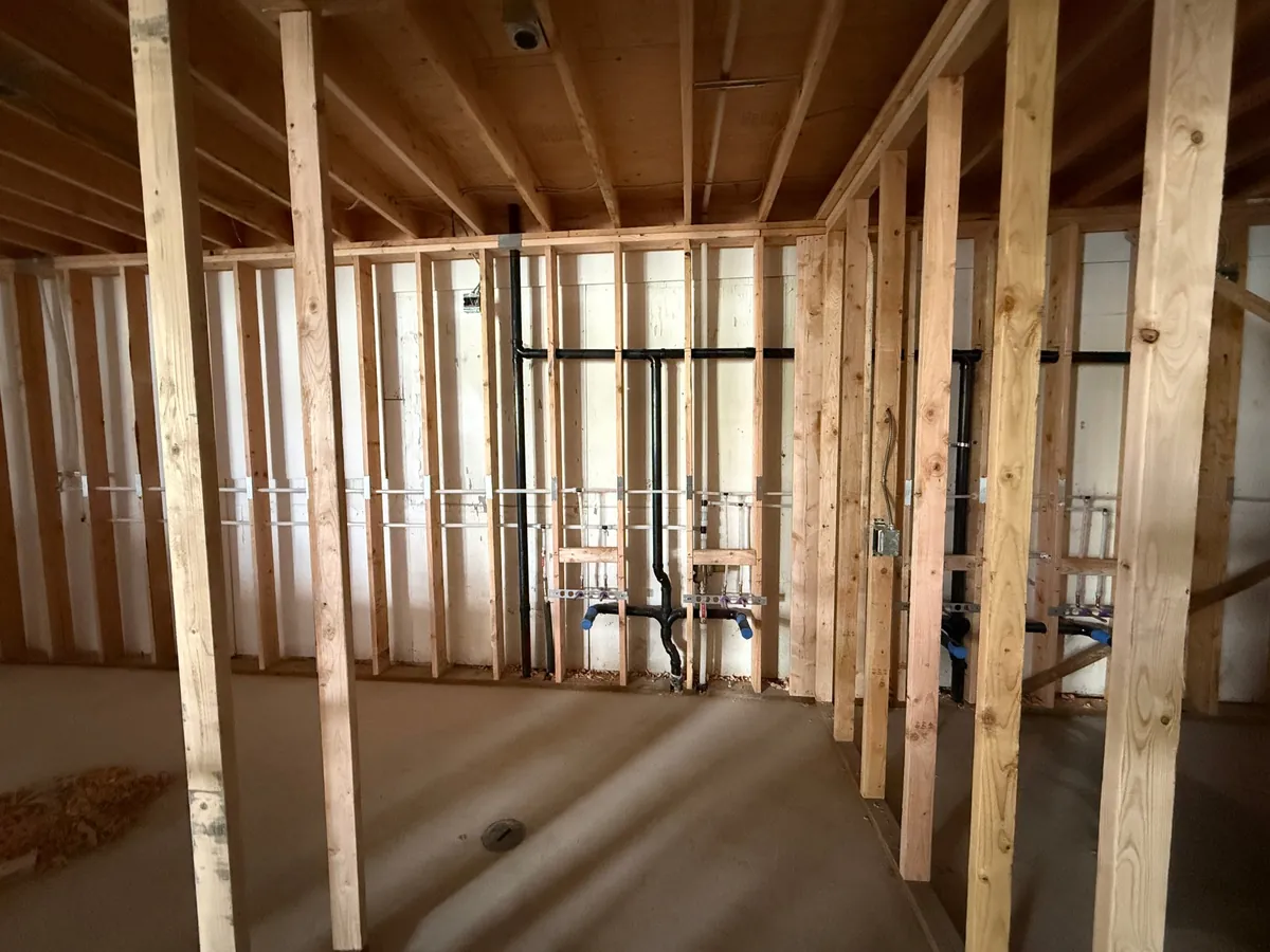 New drain and water lines roughed in through wall framing